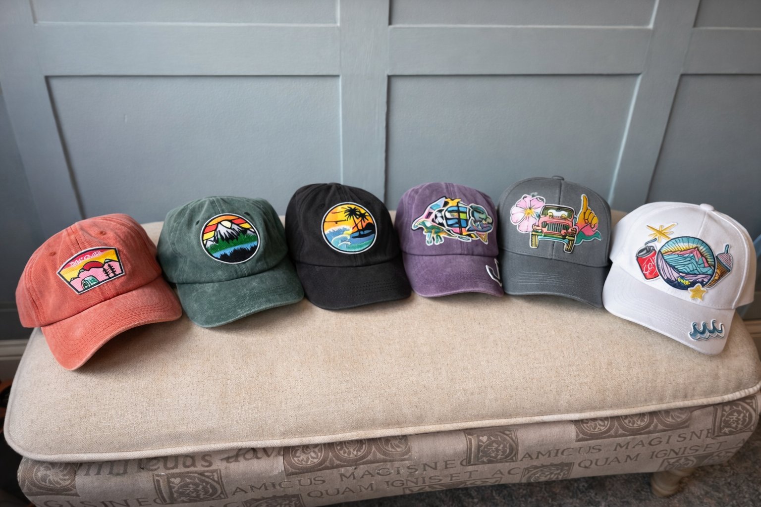 Six custom decorated hats in a row on an ottoman — party box hat activity results — Sleepover Club MD