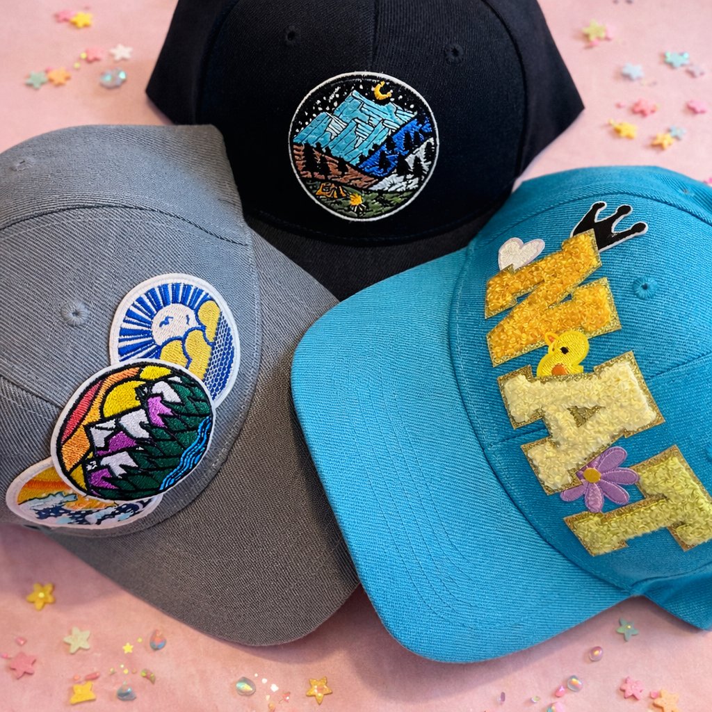 Three custom decorated hats with colorful patches on a pink star confetti background — Sleepover Club Baltimore County MD