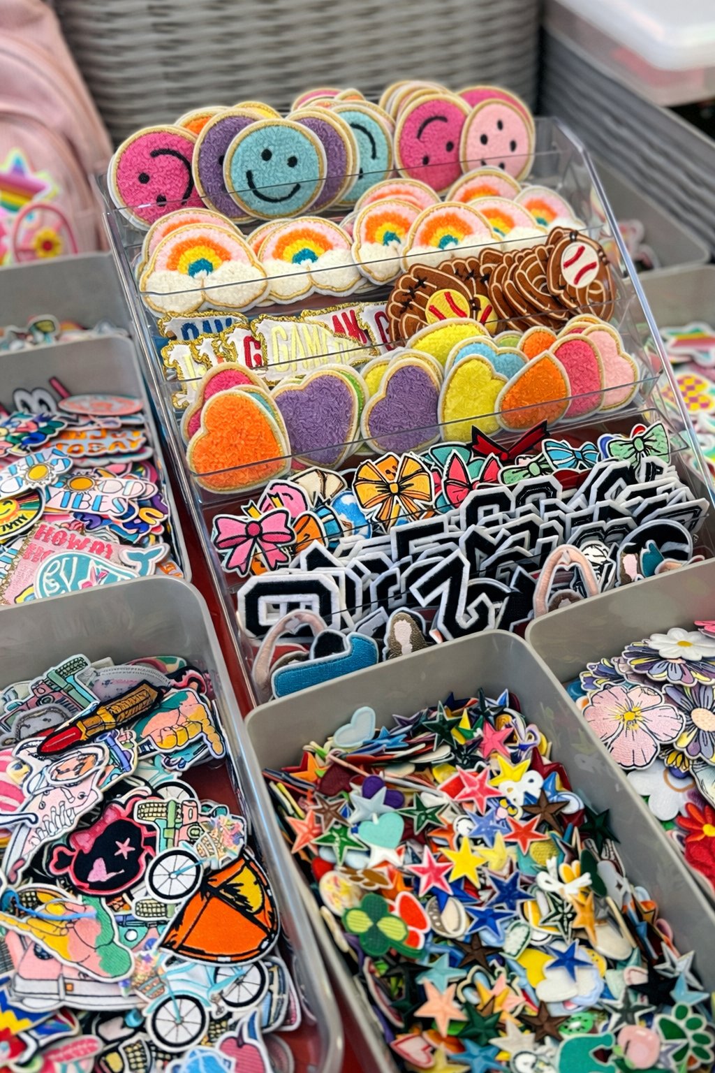 Party box patch bar with neatly organized bins of iron-on patches and stickers for kids to pick from — Sleepover Club Timonium MD