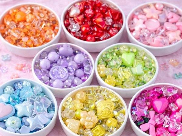 Assorted colorful acrylic charm beads in butterfly, candy, and heart shapes