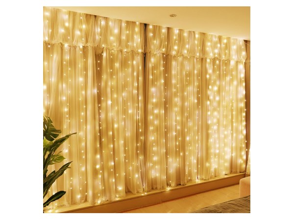 Warm white fairy curtain string lights glowing softly