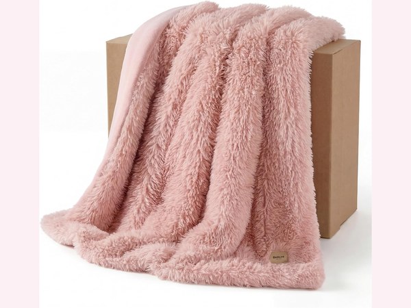 Bedsure pink faux fur throw blanket on a couch