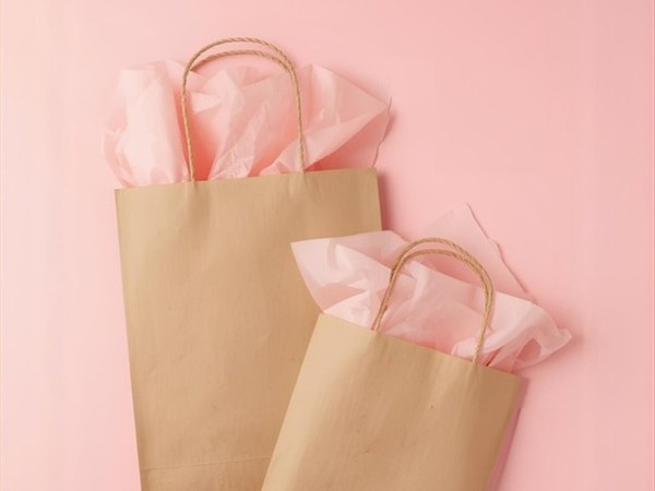 Stack of kraft paper gift bags with handles