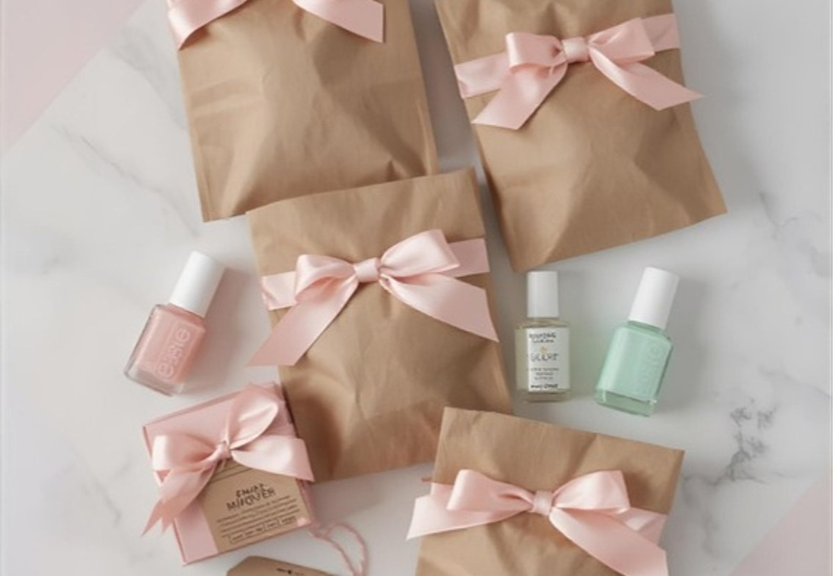 Cute sleepover party favor bags with pink ribbons and pastel packaging